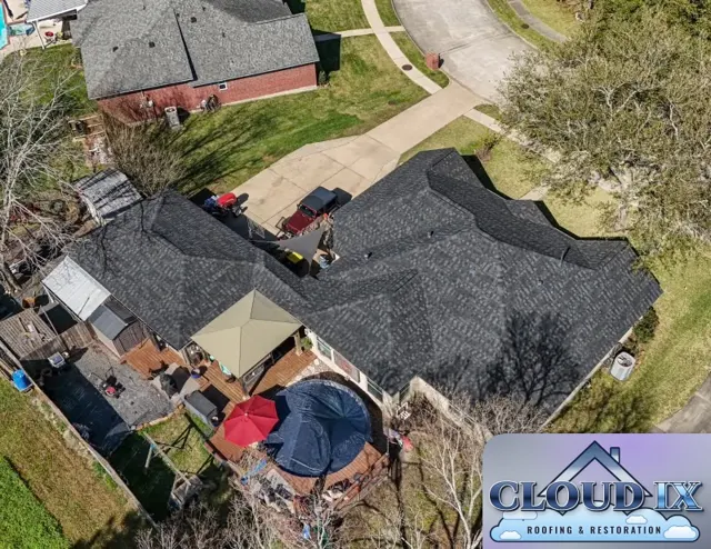 The completed hail claim roof replacement on the Magnolia home: charcoal Class 3 impact-rated architectural shingles cover every hip, valley and slope of the roof, with straight hip caps and clean lines over the garage wing. Class 3 shingles are rated under UL 2218 to withstand a 1.75-inch steel ball impact, giving this home more protection against the hail storms that move through Montgomery County than a standard shingle.
